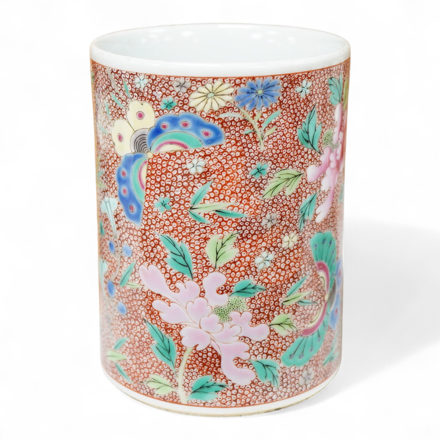 A Chinese famille rose cylindrical brush pot enamelled with butterflies amongst flowers, 14cm high